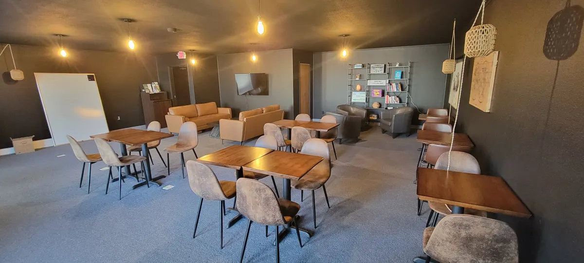 Cafe Room with wood-top tables, upholstered chairs and pendant lights